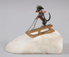 Sculpture miniature antique autrichienne en bronze représentant un teckel faisant du traîneau dans la neige.
